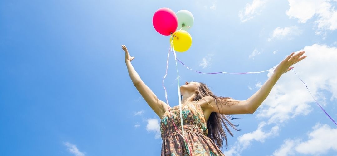 woman releasing balloon peaceful nature manifestation abundance