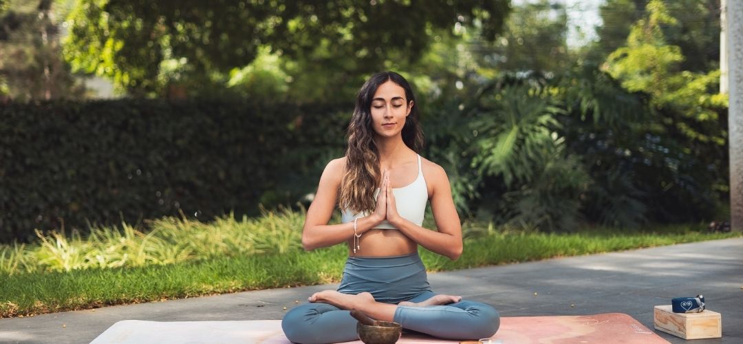 woman meditating peaceful vibration energy manifestation