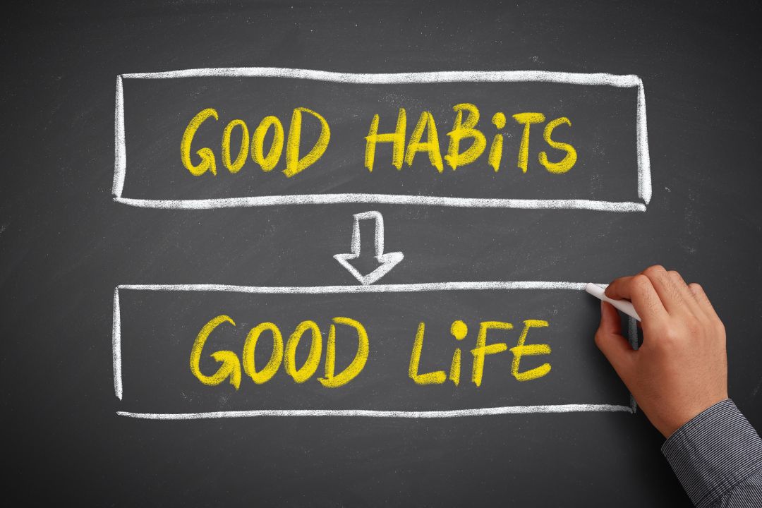 Person writing in journal applying atomic habits principles for behavior change